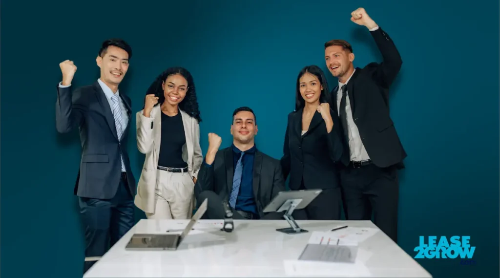 Two men and three women with right fist in aire celebrating